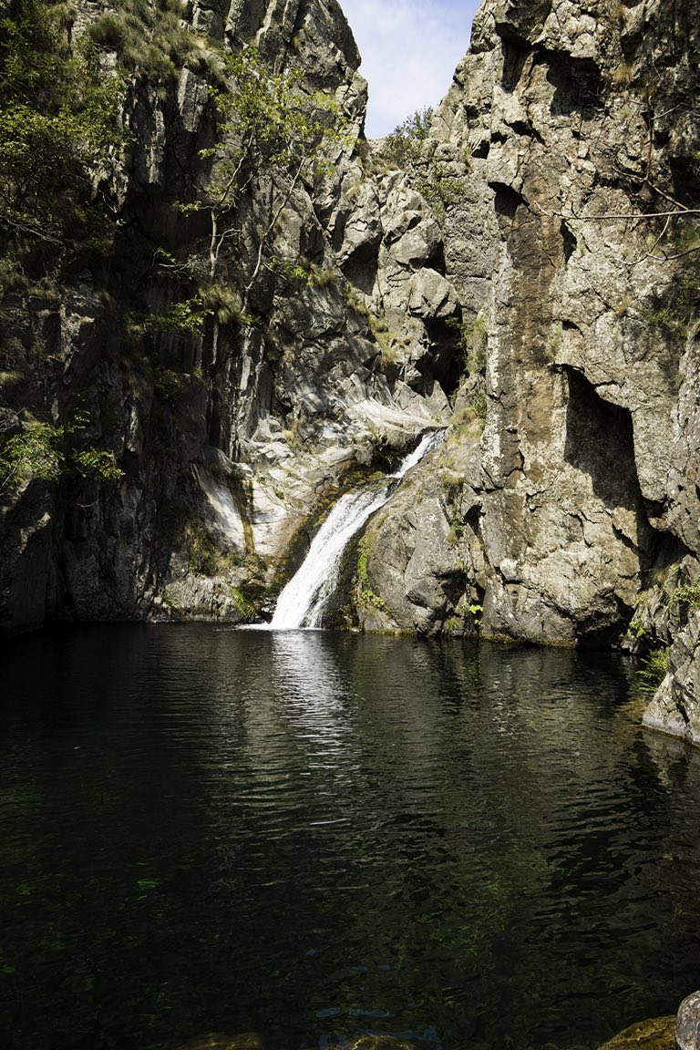 Une cascade de la Bésorgues tombant dans une vasque d'eau claire, entre les parois rocheuses