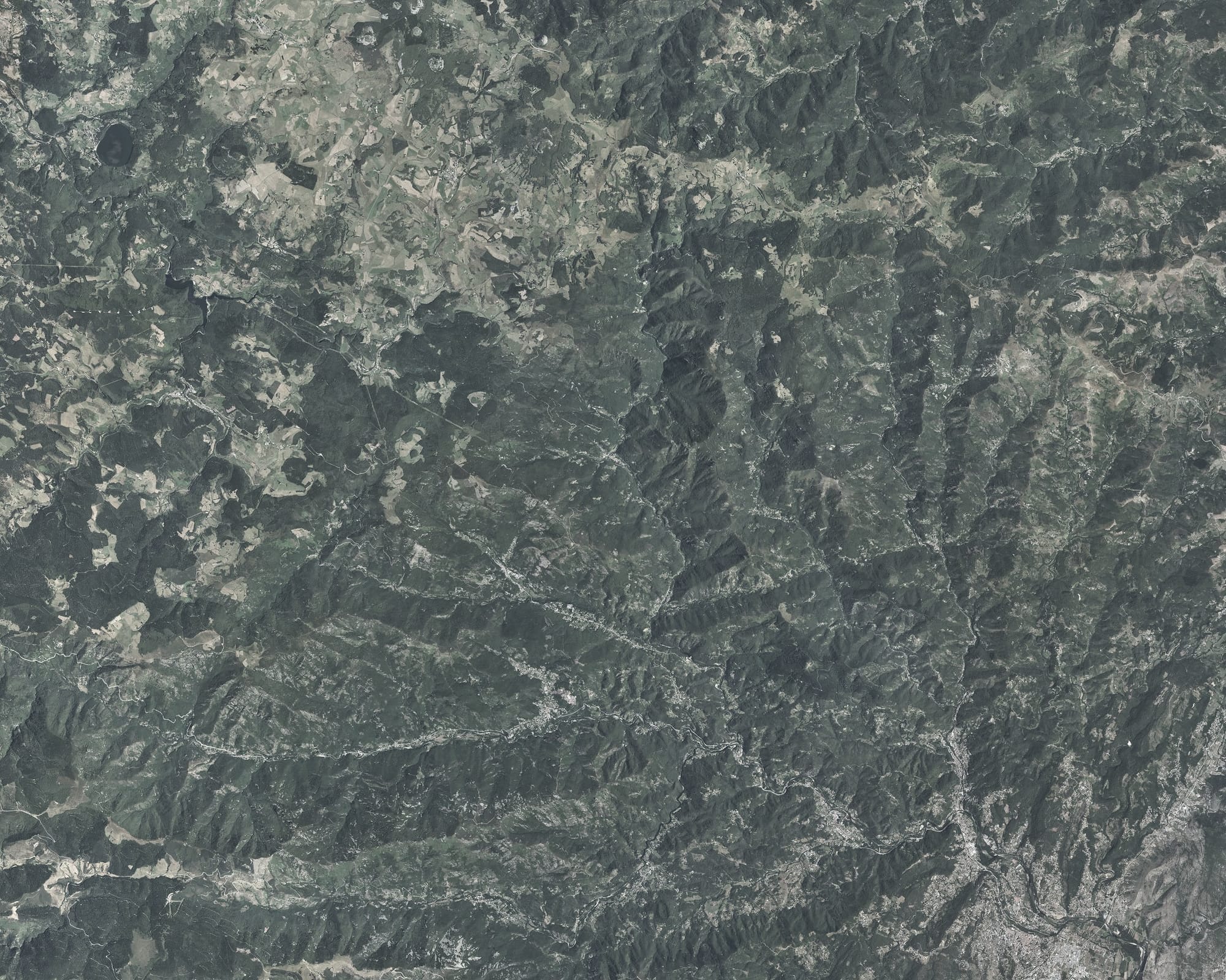 Vue aérienne de la haute vallée de l'Ardèche, des monts du plateau jusqu'à Aubenas